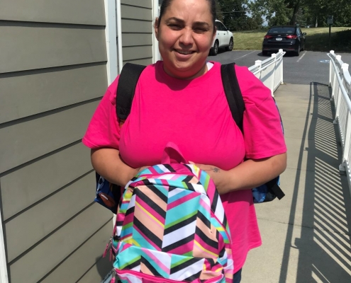woman holding a school kit bag