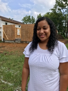 Jessy G in front of Habitat Home