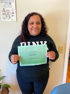 FSS Graduate Alina FSS Graduate Alina holding graduation certificate at the Reservoir St Office